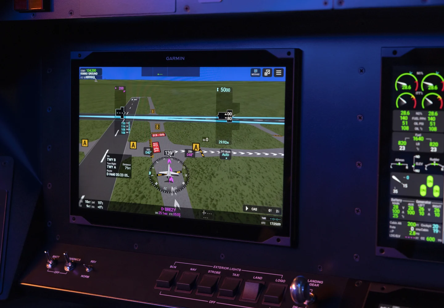 Garmin G3000 Prime 14-inch flight display mounted in a cockpit panel, showing a synthetic vision view of a runway and taxiways